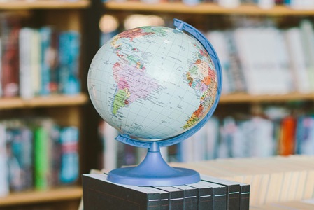 a+small+globe+placed+on+books+in+a+libary a+small+globe+placed+on+books+in+a+libary