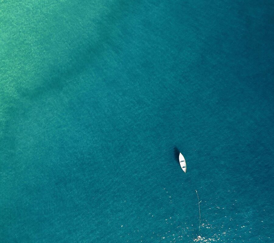 image-of-the-ocean-with-a-small-boat-sailing image-of-the-ocean-with-a-small-boat-sailing